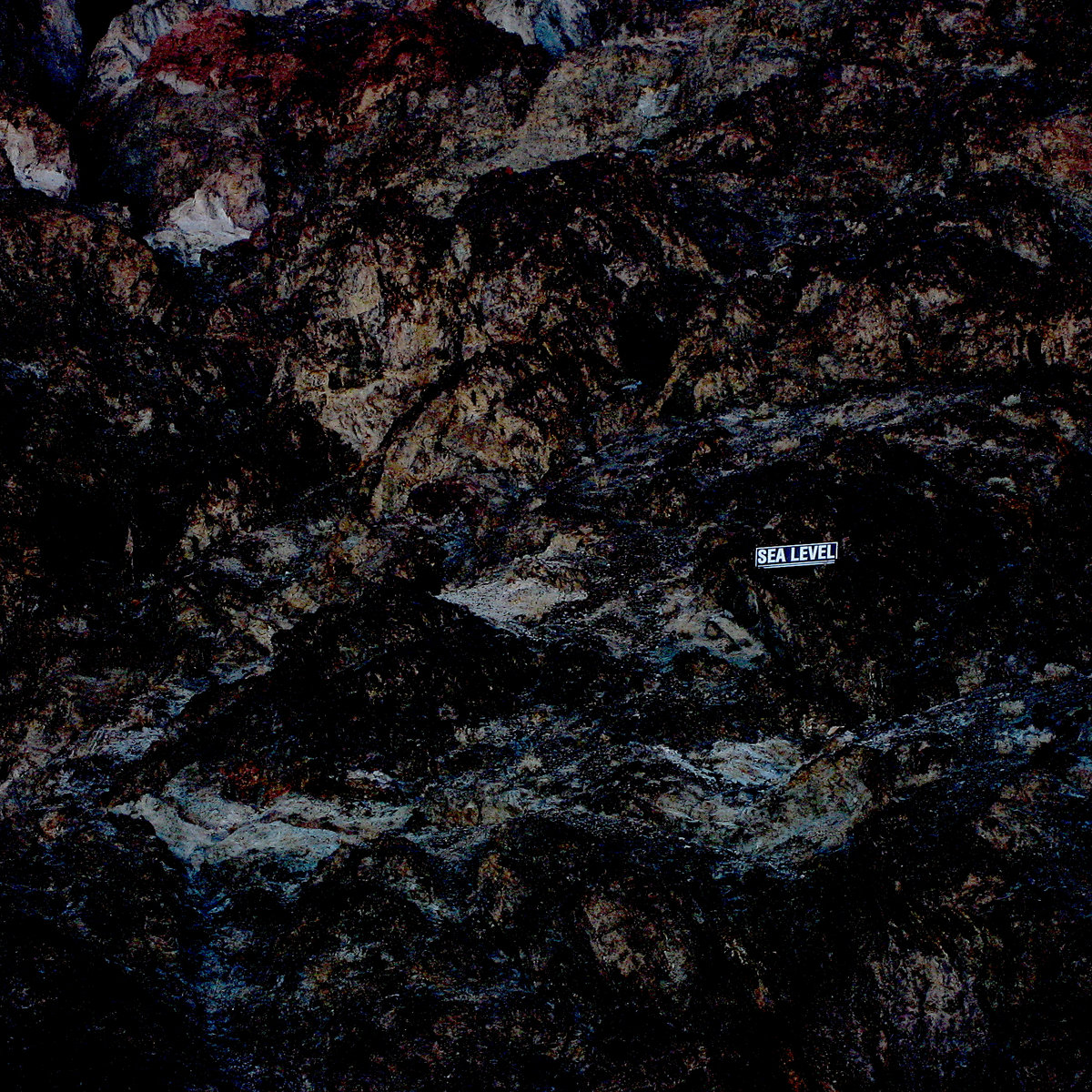 photo of rock face with small sign saying sea level, album cover for distant reader album