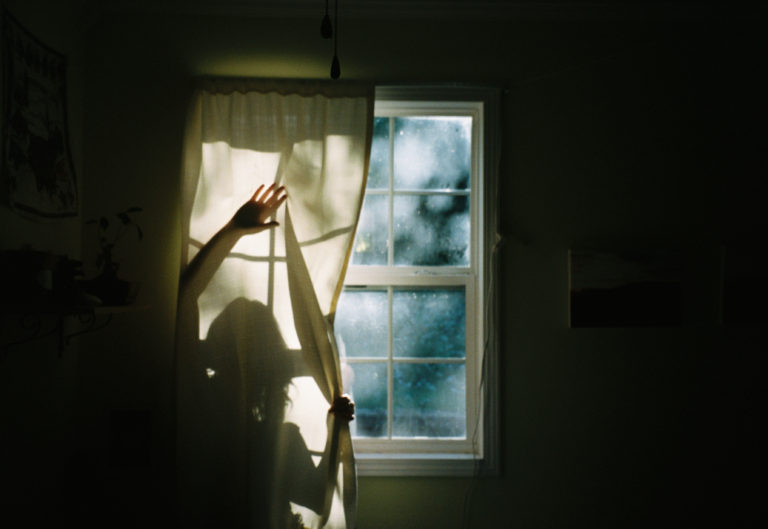 photo of artist Lou Turner in silhouette against a window