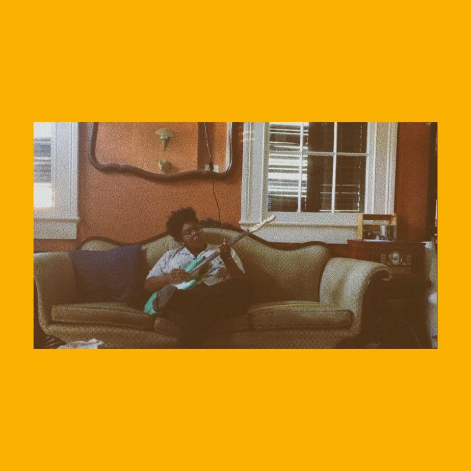 Qween Paz hold on up cover art - photo of qween paz sitting on a couch holding a guitar pasted on an orange background