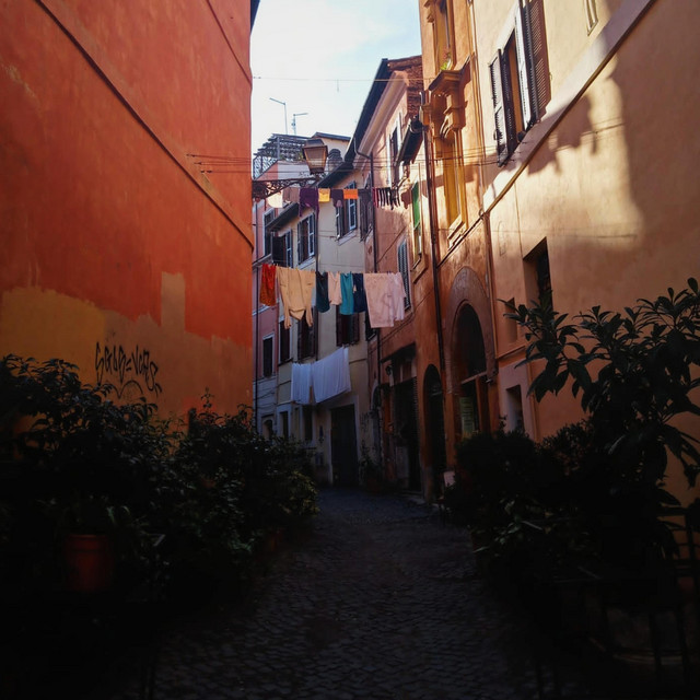 cover for welcomed by permanent vacation - photo of a european street in the sunsine