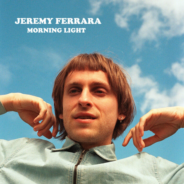 jeremy ferrara morning light - photo of jeremy from the shoulders up against a blue sky with white clouds