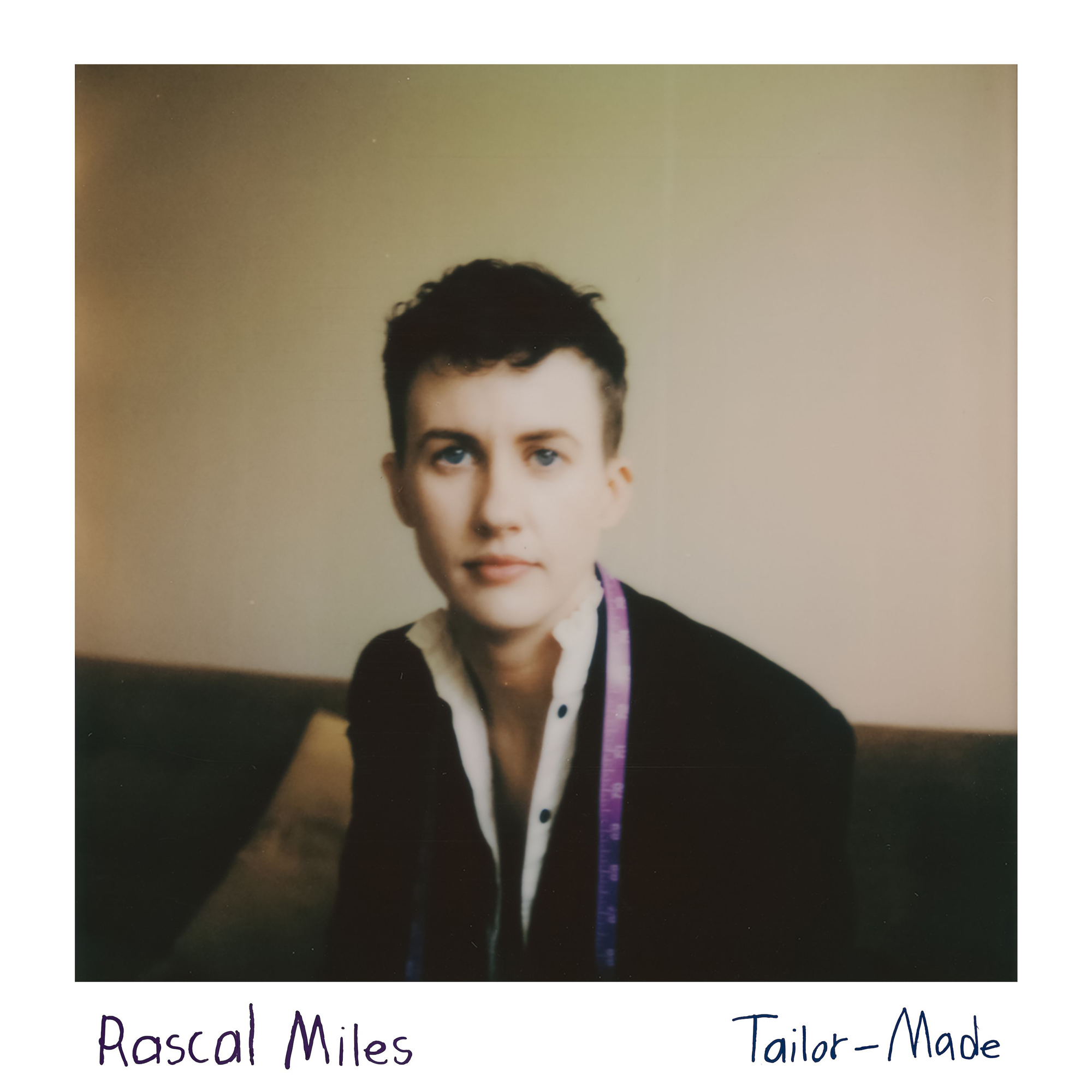 Rascal Miles Tailor-made single art - polaroid photo of Miles sitting on a couch with a purple measuring tape around their neck