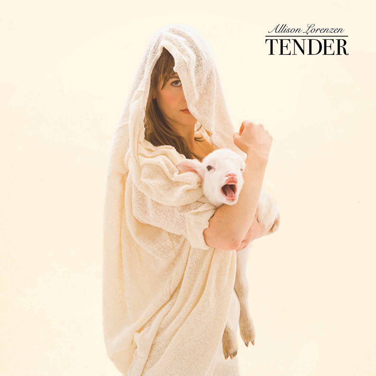 Photo of Allison Lorenzen draped in white cloth holding a lamb