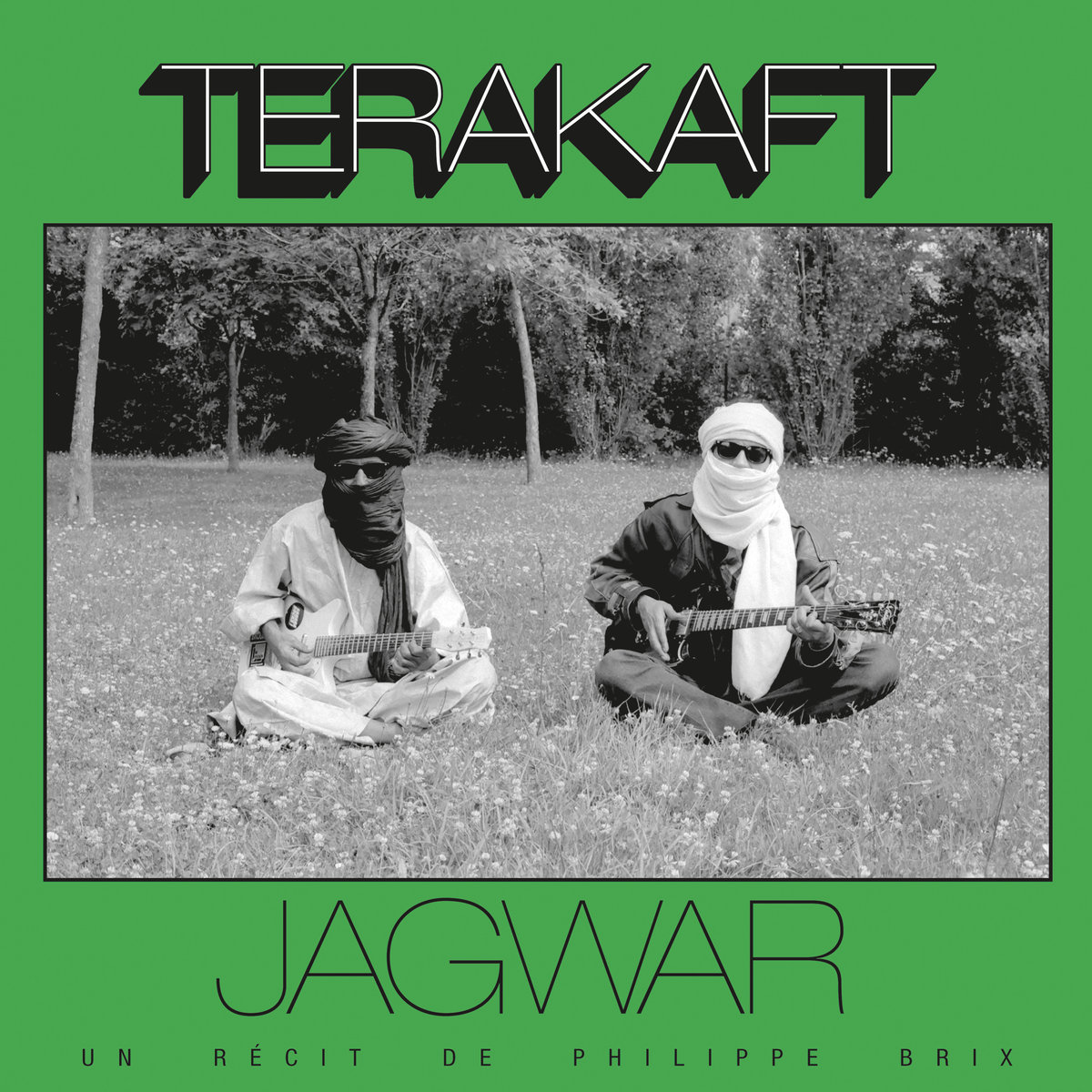 terakaft jagwar - photo of two men in headscarves sitting on grass and playing guitars