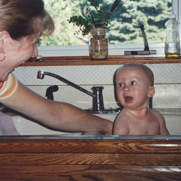 wheres beth for my mom and other lovers - photo of a woman bathing a baby in the kitchen sink