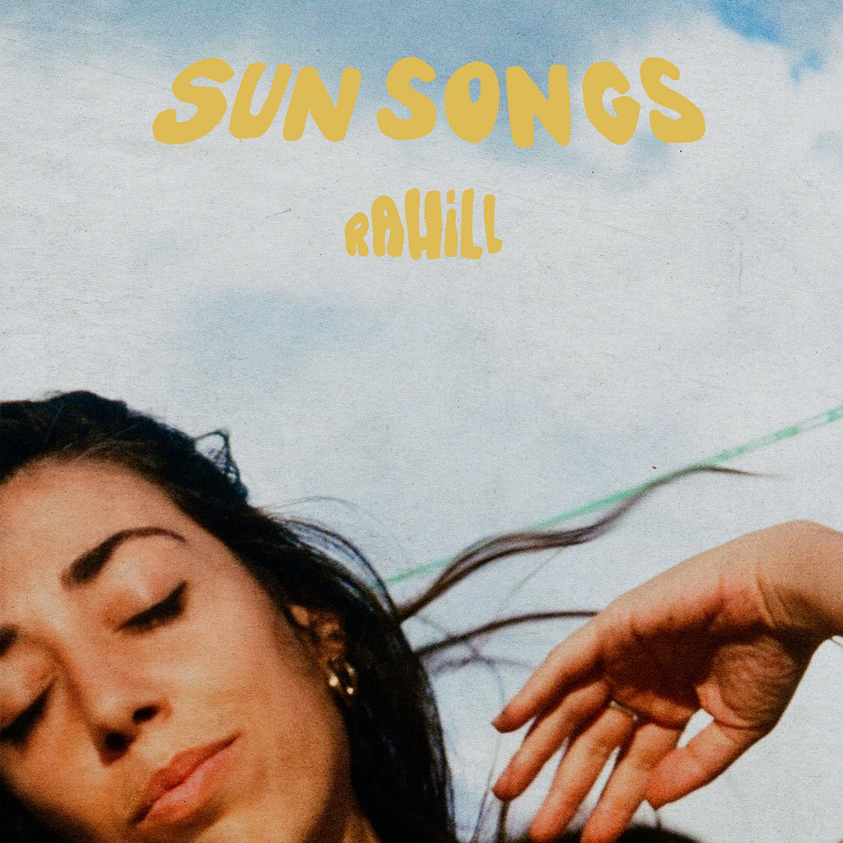 rahill sun songs - photo of a woman's face against a pale blue sky