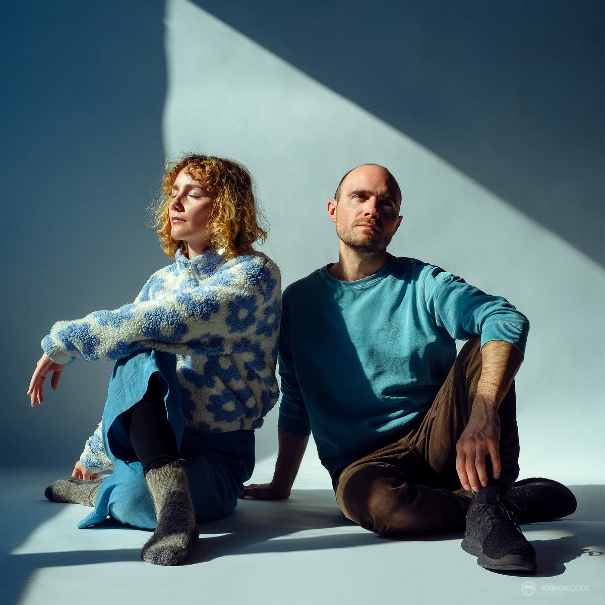 best fern earth then air cover art - photo of Alexia Avina and Nick Schofield in a ray of sunlight against a pale blue background