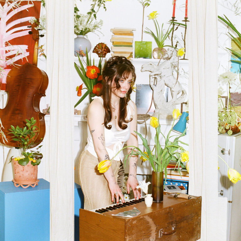bria cuntry covers vol 2 album art - photo of Bria playing a small piano surrounded by plants