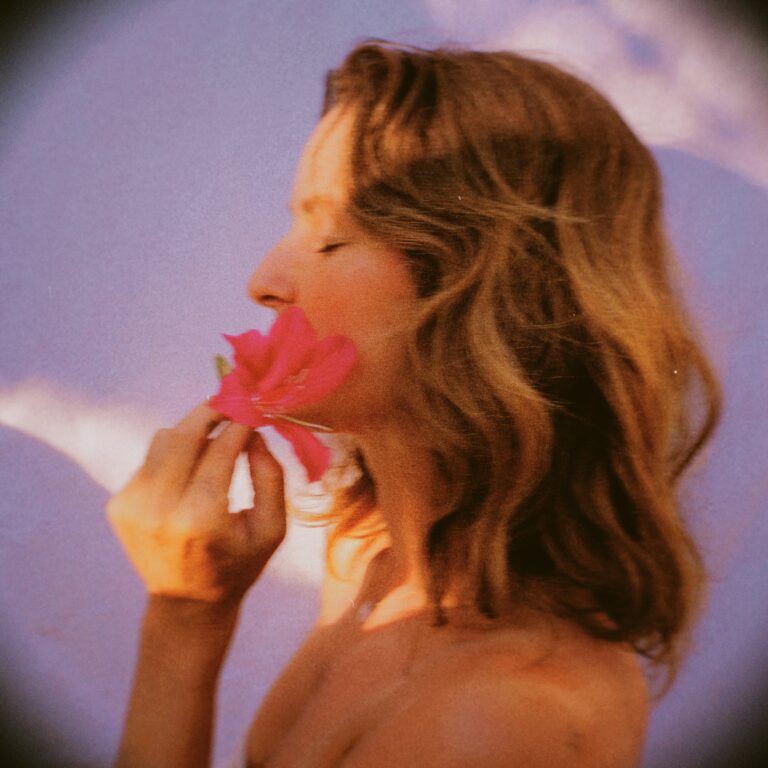 A picture of Rose Brokenshire holding a pink flower